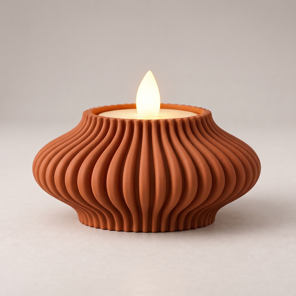 DiyArts Fluted Tealight Candle Holder in Burnt Rust, sculptural ribbed fins with an LED tealight, studio product shot