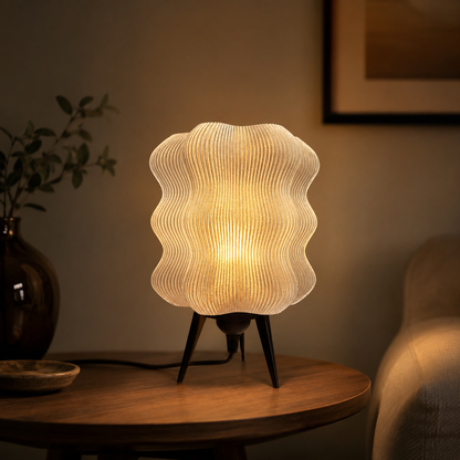 Wave Table Lamp in Amber glowing in a cozy living room
