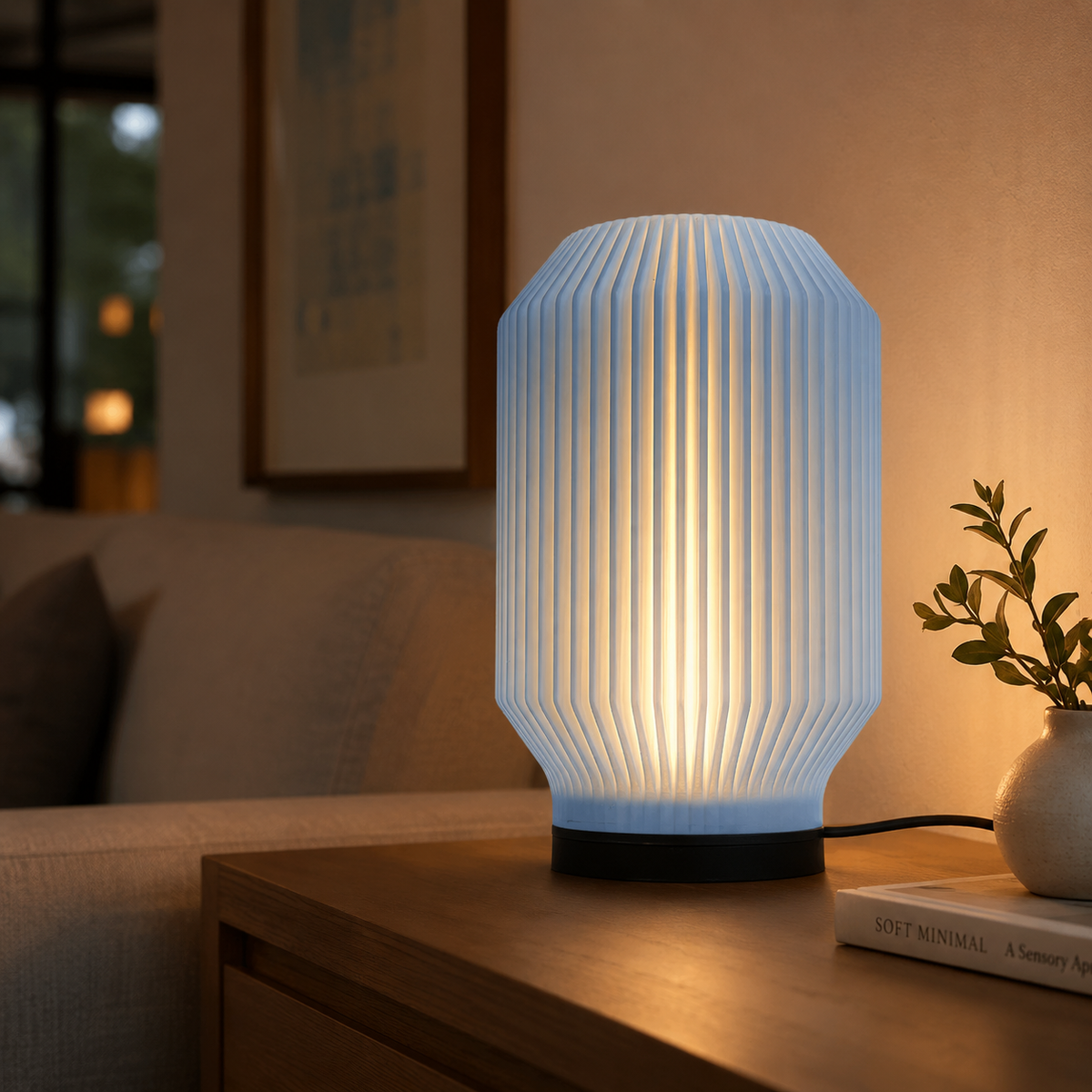 Lantern Ribbed Table Lamp in Light Blue glowing in a cozy living room