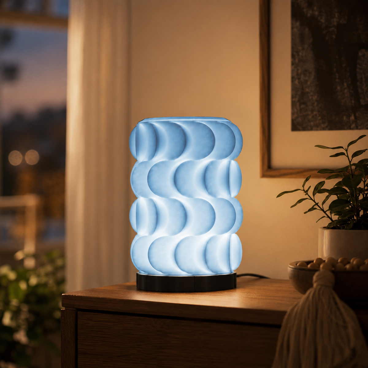 Scallop Table Lamp in Light Blue glowing in a cozy room