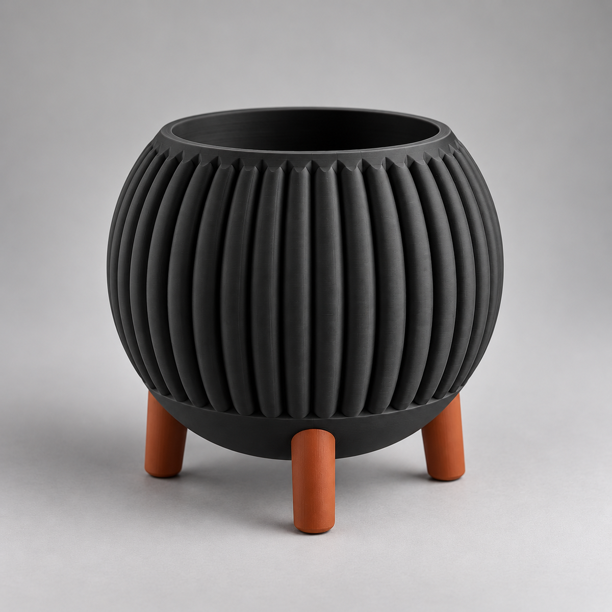 DiyArts Ribbed Planter with Legs in Matte Black with burnt rust legs, fluted mid-century plant pot, studio product shot
