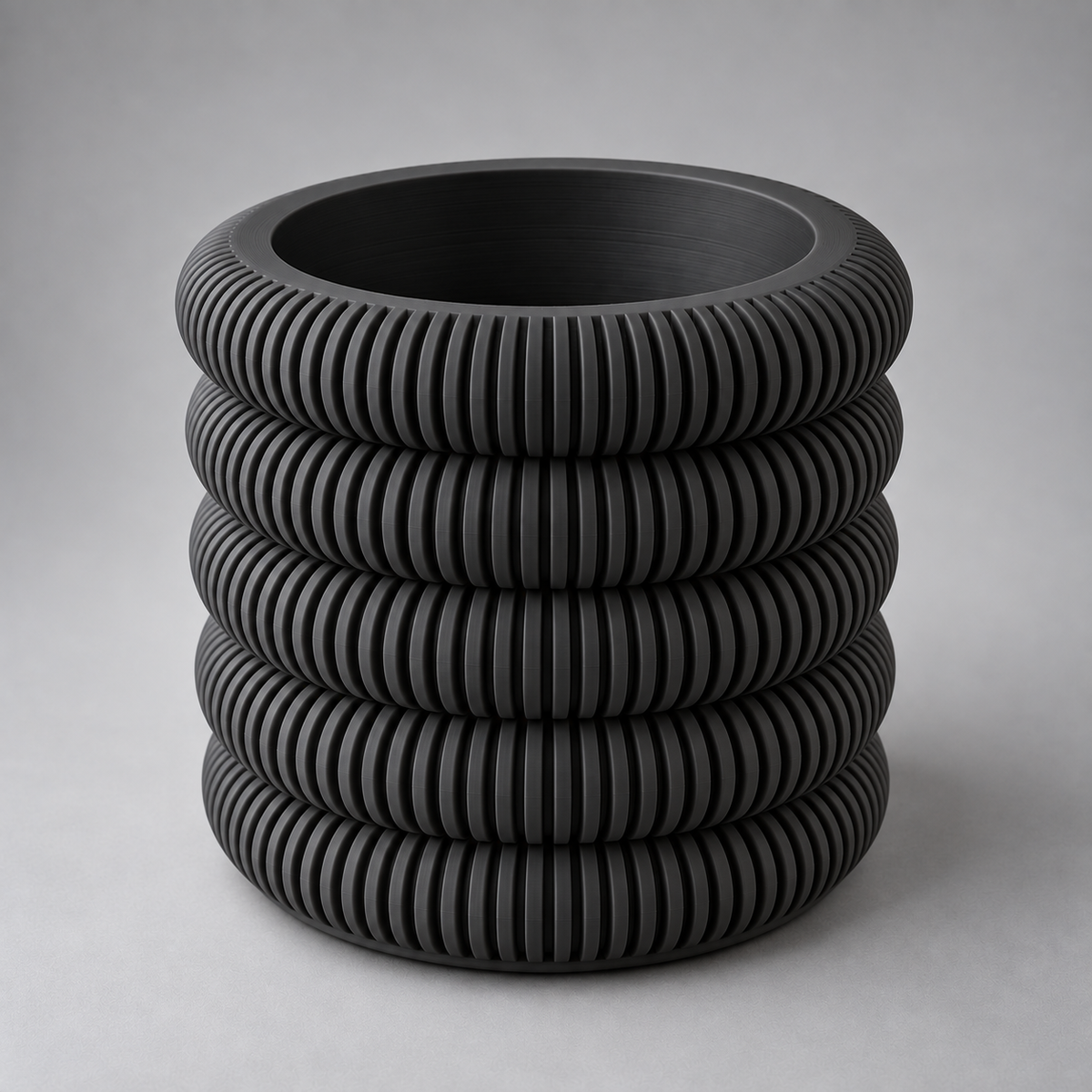 DiyArts Coin Stack Planter with Drip Tray in Matte Black, five stacked ribbed rings, studio product shot
