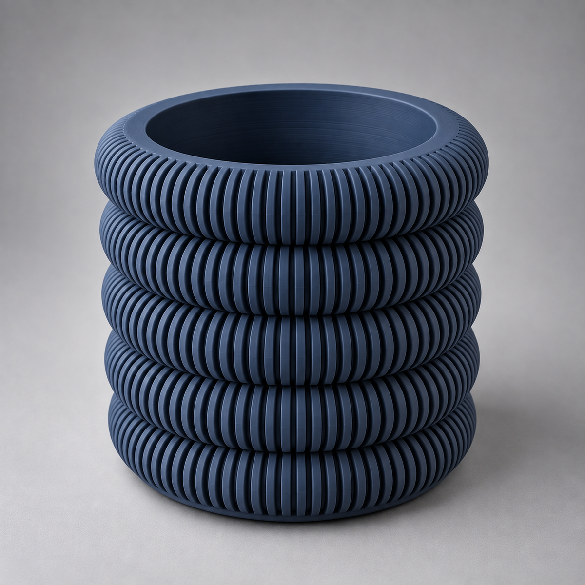 DiyArts Coin Stack Planter with Drip Tray in Deep Indigo Blue, five stacked ribbed rings, studio product shot