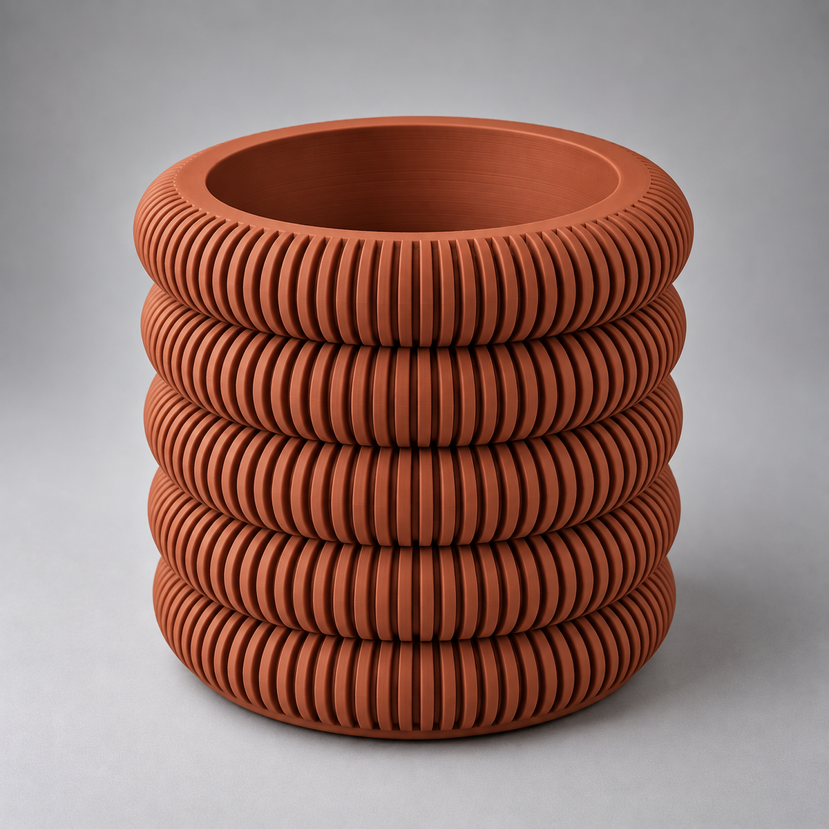 DiyArts Coin Stack Planter with Drip Tray in Burnt Rust, five stacked ribbed rings, studio product shot