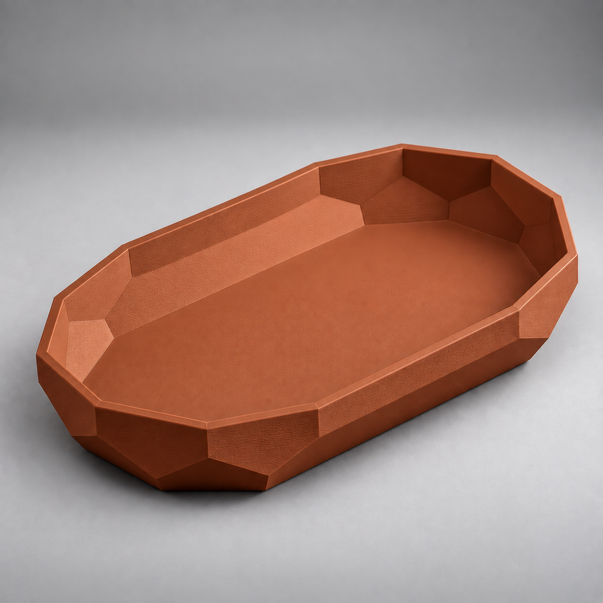 DiyArts Facet Oval Catch-All Tray in Burnt Rust, faceted geometric wall, studio product shot