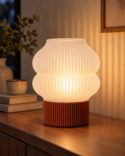 Ripple Table Lamp, Double Bubble shade in Jade White, glowing on a wooden console table