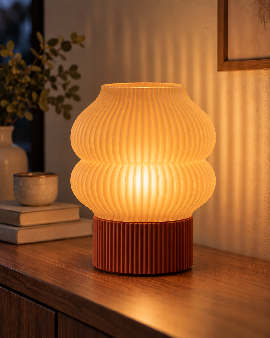 Ripple Table Lamp, Double Bubble shade in Translucent Honey, glowing on a wooden console table