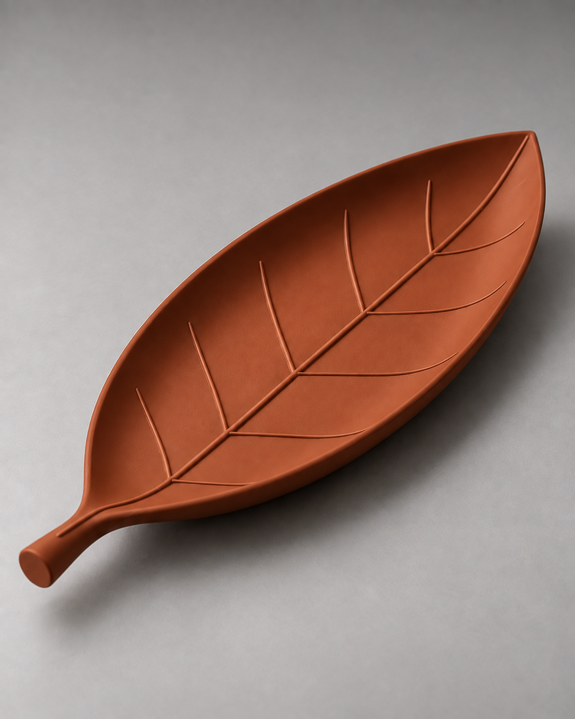 DiyArts Leaf Catch-All Tray in Burnt Rust, leaf-shaped dish with sculpted veins, studio product shot