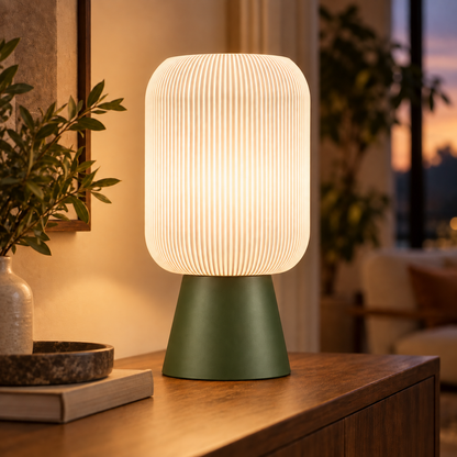 Column Ribbed Table Lamp, Cone base in Moss Green, glowing on a wooden console table