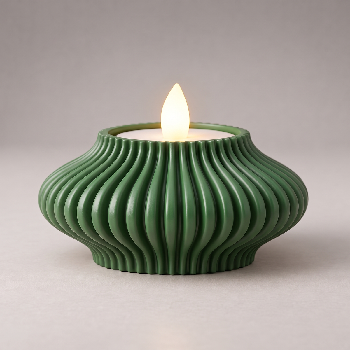 DiyArts Fluted Tealight Candle Holder in Mistletoe Green, sculptural ribbed fins with an LED tealight, studio product shot