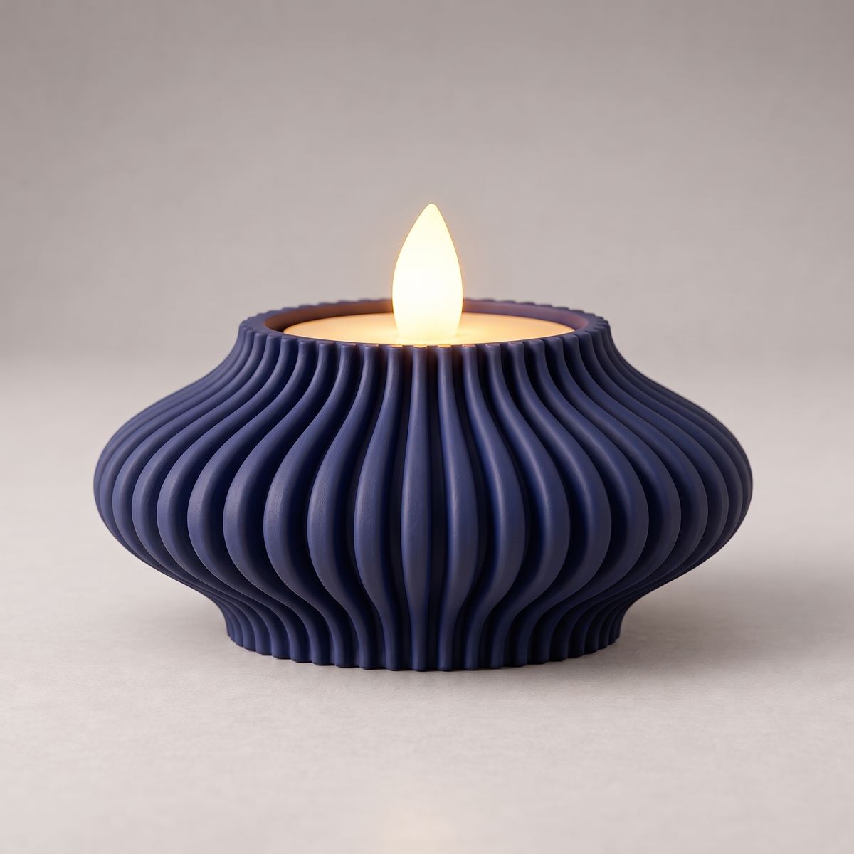 DiyArts Fluted Tealight Candle Holder in Deep Indigo Blue, sculptural ribbed fins with an LED tealight, studio product shot
