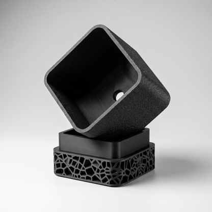 Voronoi Square Planter in Matte Black shown apart - pot with drainage hole and the Voronoi lattice drip tray base