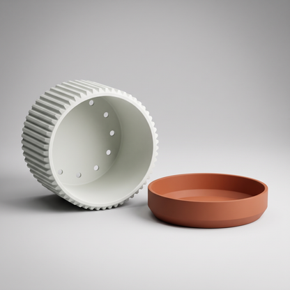 Fluted Cylinder Planter in Jade White shown apart - pot underside with seven drainage holes and the burnt rust saucer