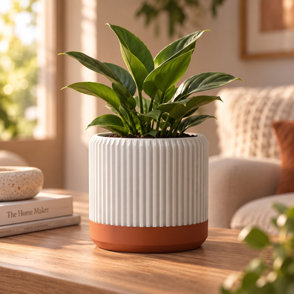 Fluted Cylinder Planter in Jade White holding a peace lily on an oak coffee table
