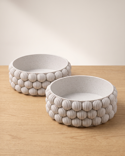 Bubble Bowl Pair: two DiyArts 3D printed Bubble Catch-All Bowls in White Marble, wide low ribbed bowls side by side on a light oak surface, studio shot