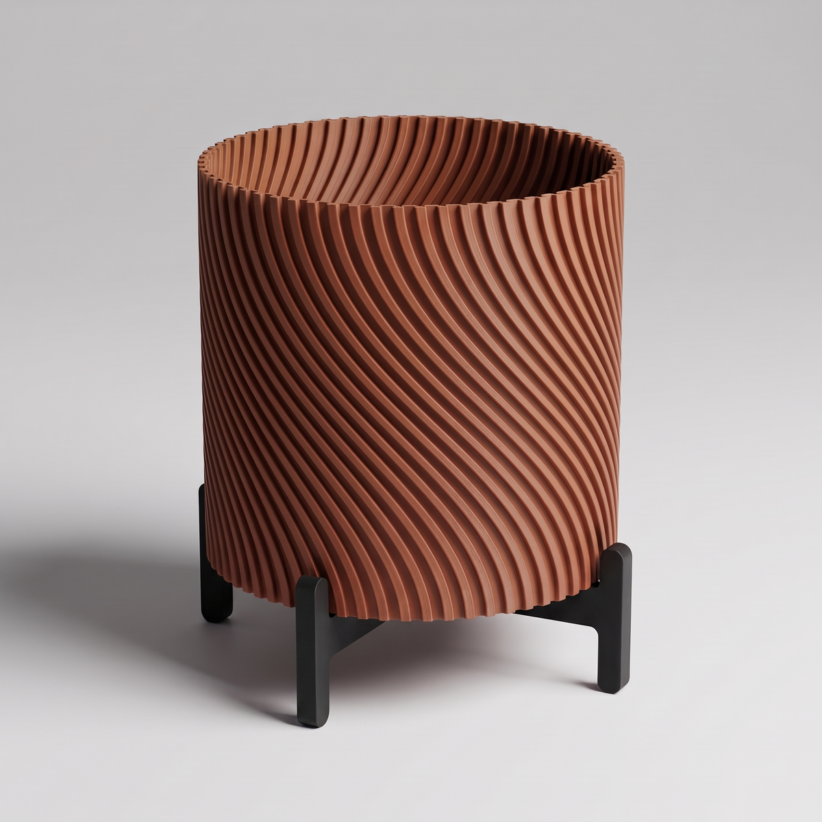 DiyArts Twisted Planter with Stand in Burnt Rust with matte black cross stand, 4 inch spiral ribbed plant pot, studio product shot