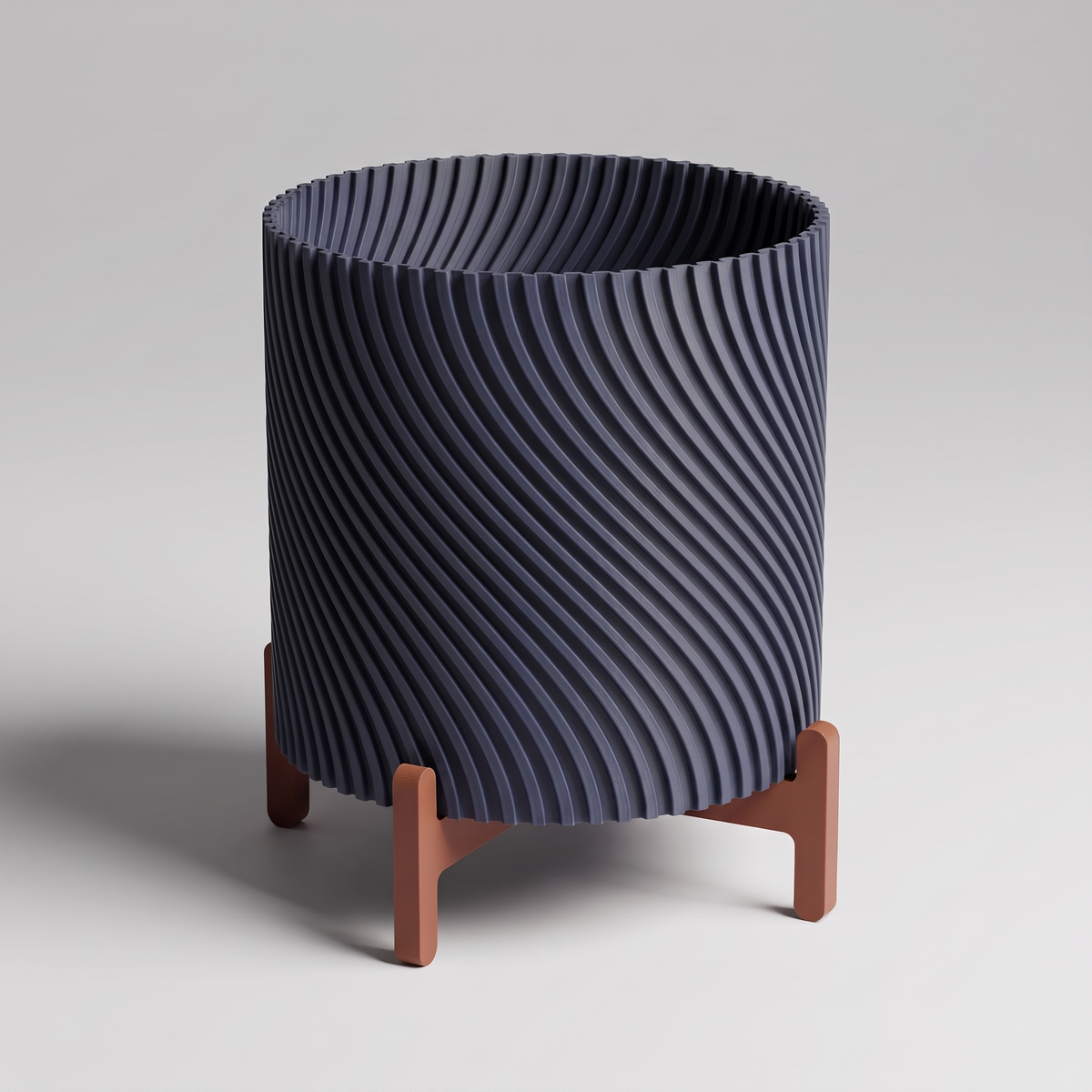DiyArts Twisted Planter with Stand in Deep Indigo Blue with burnt rust cross stand, 4 inch spiral ribbed plant pot, studio product shot