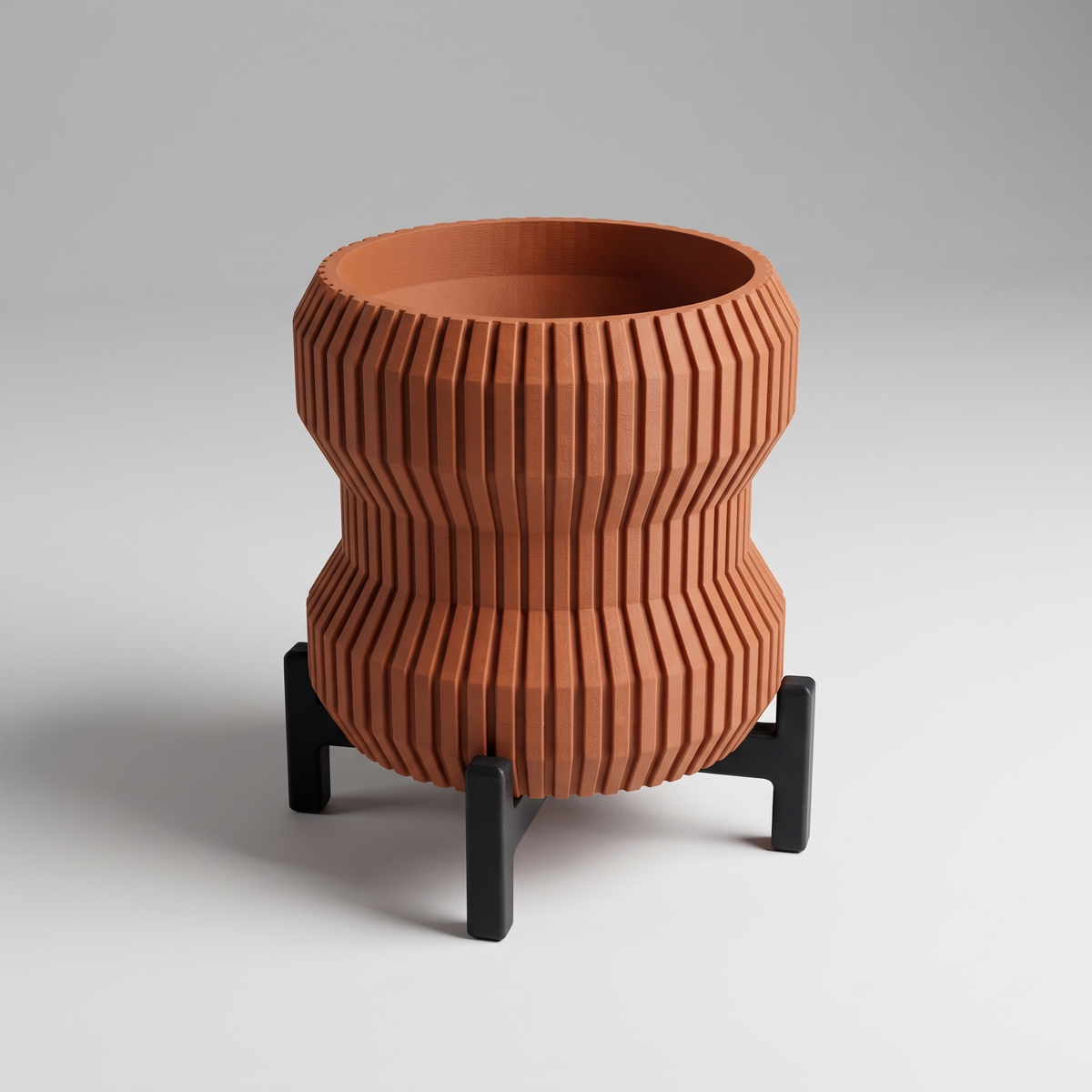 DiyArts Waisted Fluted Planter with Stand in Burnt Rust with matte black cross stand, 5 inch hourglass ribbed plant pot, studio product shot