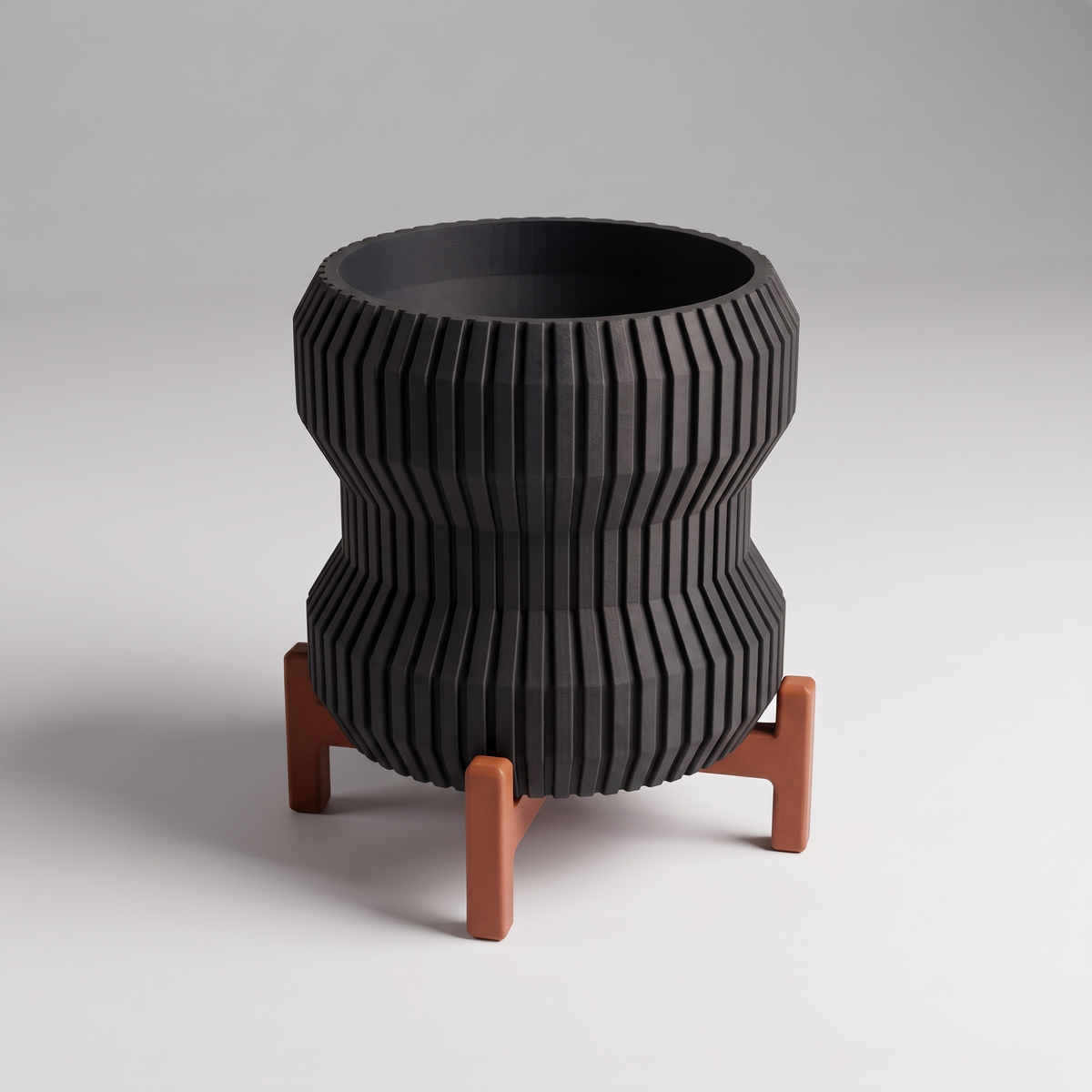 DiyArts Waisted Fluted Planter with Stand in Matte Black with burnt rust cross stand, 5 inch hourglass ribbed plant pot, studio product shot