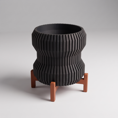 DiyArts Waisted Fluted Planter with Stand in Matte Black with burnt rust cross stand, 5 inch hourglass ribbed plant pot, studio product shot