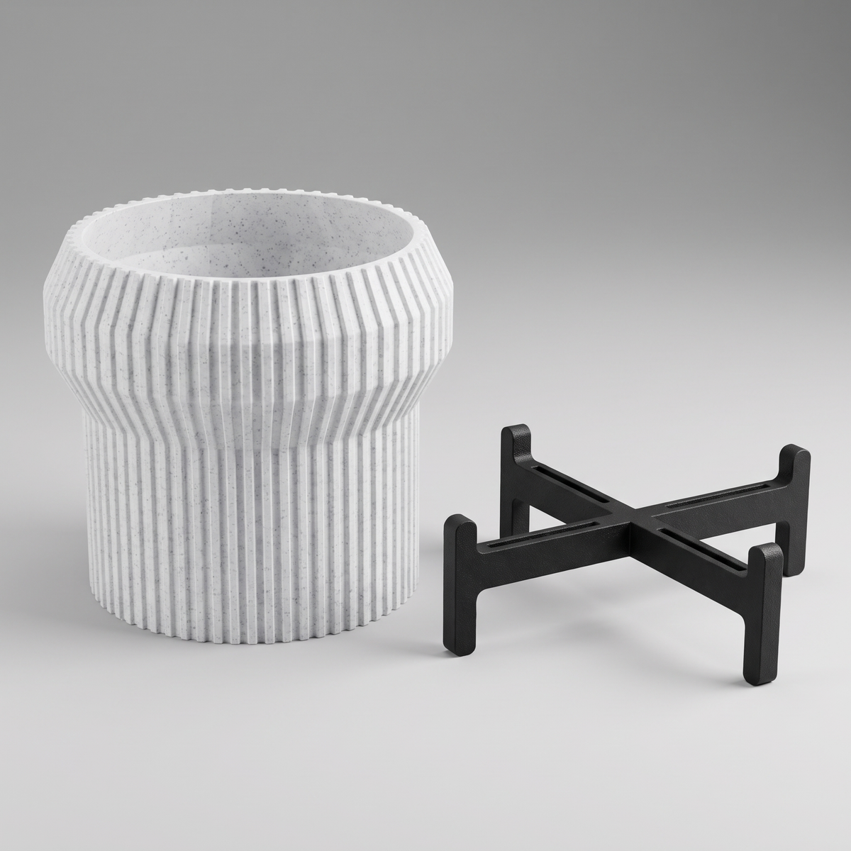 Flared Fluted Planter shown apart - flared fluted pot in White Marble and the matte black slotted cross stand with upturned tabs