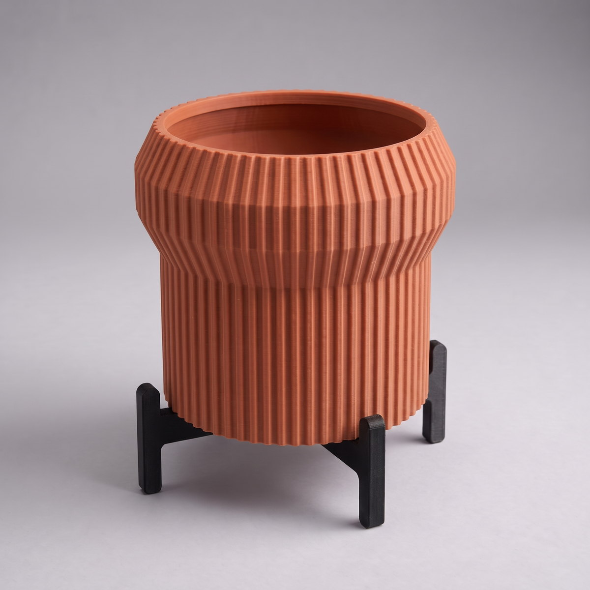 DiyArts Flared Fluted Planter with Stand in Burnt Rust with matte black cross stand, 5 inch ribbed plant pot, studio product shot
