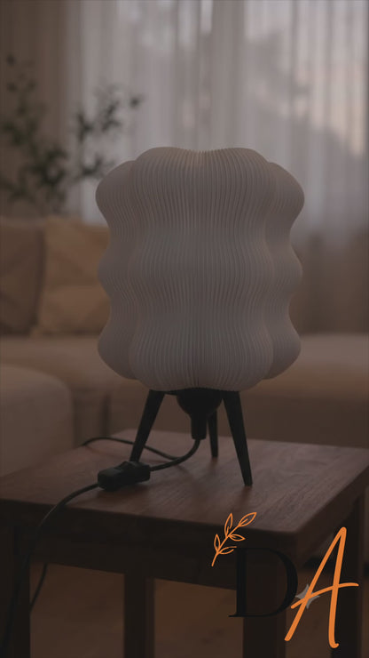 Wave Table Lamp turning on, glowing warmly in a living room