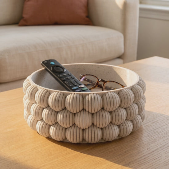 Slow orbit around the DiyArts Bubble Catch-All Bowl in White Marble on an oak coffee table, showing the ribbed bubble texture of the 3D printed bowl