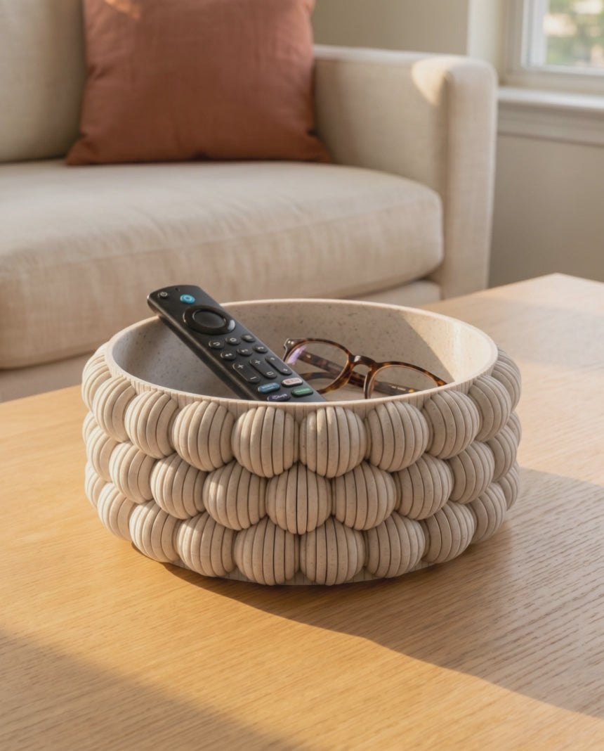 Slow orbit around the DiyArts Bubble Catch-All Bowl in White Marble on an oak coffee table, showing the ribbed bubble texture of the 3D printed bowl