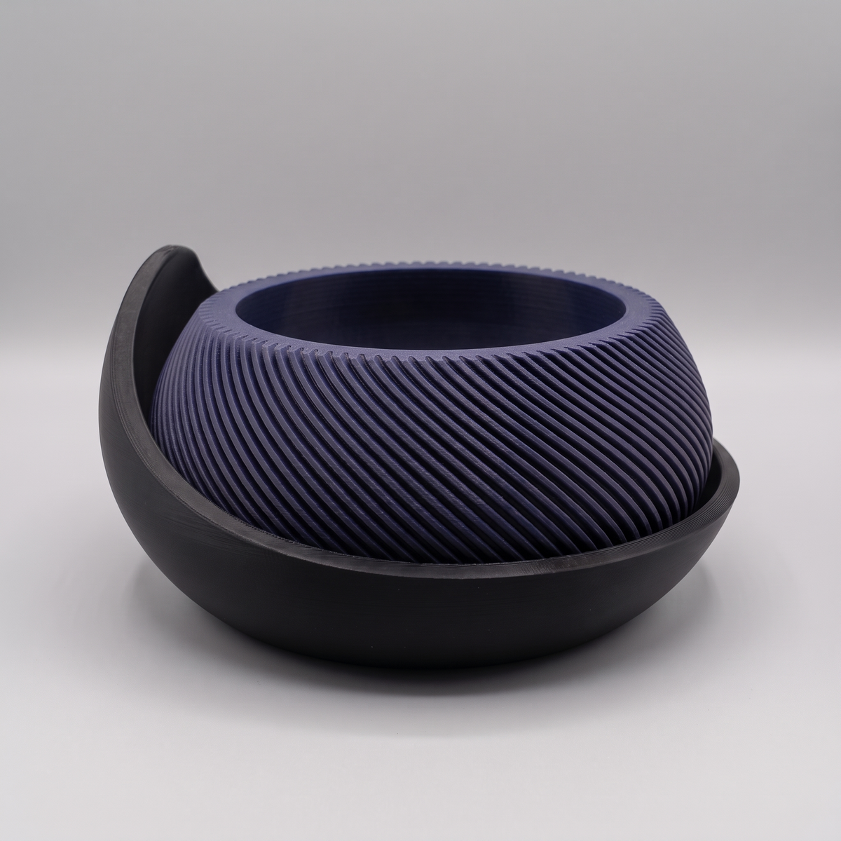 Swirl Ribbed Bowl Planter with Cradle Saucer in Deep Indigo Blue with a Matte Black saucer, studio view