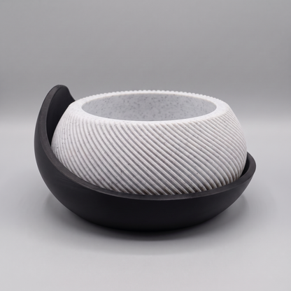 Swirl Ribbed Bowl Planter with Cradle Saucer in White Marble with a Matte Black saucer, studio view